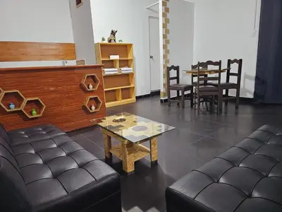 a living room with a couch and a table at Chakanas House in Cusco