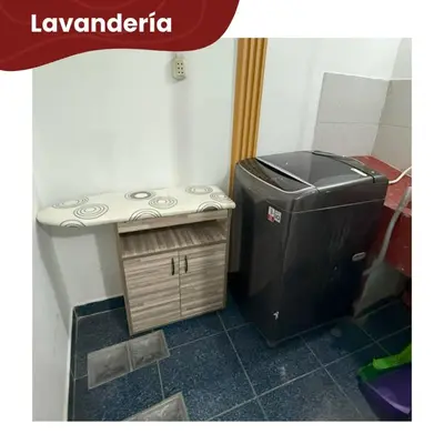 a small refrigerator and a small table in a room at Departamentos Sumaq Plaza - Mariscal Cáceres in Ayacucho