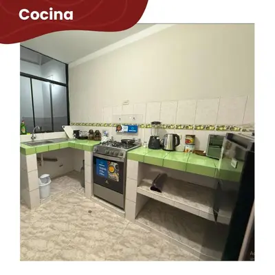 a kitchen with green counter tops and a stove at Departamentos Sumaq Plaza - Mariscal Cáceres in Ayacucho