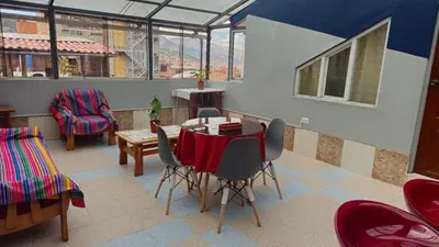a dining room with a table and chairs in a room at Cozy Mini-Apartment-Cusco in Cusco