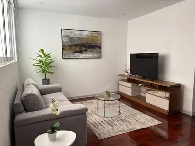 a living room with a couch and a tv at 2Br Apartment Miraflores in Lima