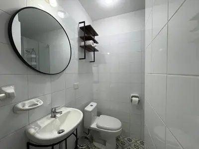 a white bathroom with a sink and a mirror at 2Br Apartment Miraflores in Lima