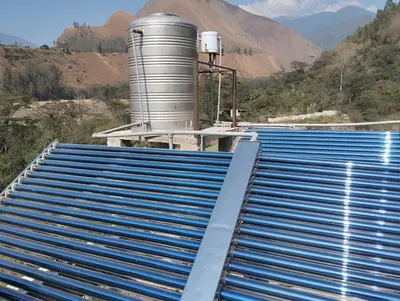 a view of a roof of a factory with mountains in the background at Glamping Machupicchu Lodge in Santa Teresa