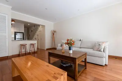 a living room with a couch and a coffee table at Duplex in the best area of Barranco in Lima