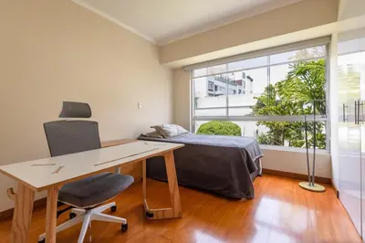 a bedroom with a desk and a bed and a window at Duplex in the best area of Barranco in Lima