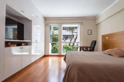 a bedroom with a bed and a large window at Duplex in the best area of Barranco in Lima