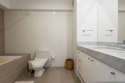 a white bathroom with a toilet and a sink at Duplex in the best area of Barranco in Lima