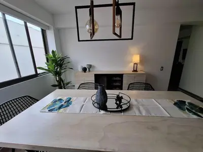a dining room with a white table and chairs at Inka Home VIP Luxury total 2 Private parking spaces in Lima