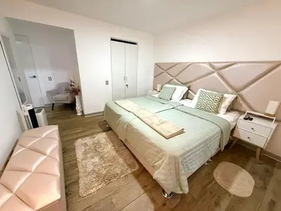 a bedroom with a large bed with a large headboard at Inka Home VIP Luxury total 2 Private parking spaces in Lima