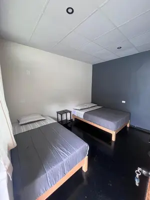 two beds sitting in a room with at La Posada de Chango in La Merced