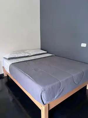 a bed sitting in a room with a mattress at La Posada de Chango in La Merced