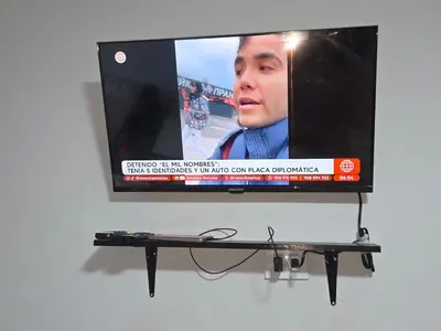 a flat screen tv hanging on a wall at Mar y luz in Lima