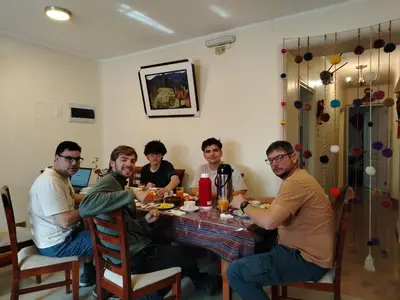 a group of men sitting around a table at Imperium House Cusco in Cusco