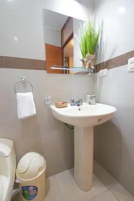 a bathroom with a sink and a mirror at Elite Apartment in Cusco