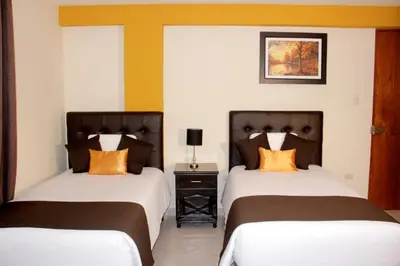 two beds sitting next to each other in a bedroom at Hostel Esperanza in Lima