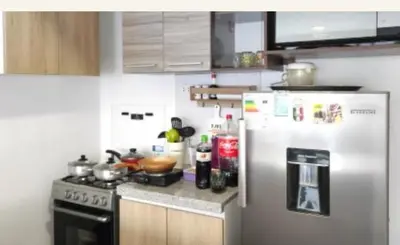 a kitchen with a stainless steel refrigerator and a stove at Milyshomeperu in Lima