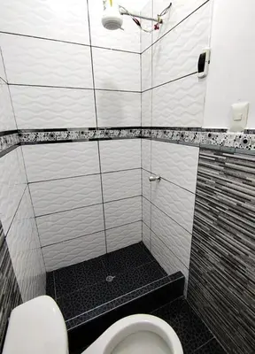 a small bathroom with a toilet and a shower at Casa de campo familiar cn parrilla, WiFi y piscina