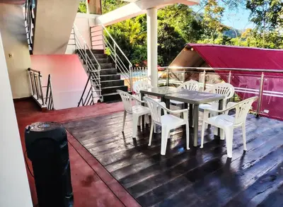 a table and chairs on a deck with stairs at Casa de campo familiar cn parrilla, WiFi y piscina