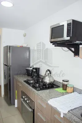 a kitchen with a stove and a microwave at Cozy apartment in San Miguel in Lima