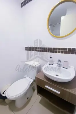 a bathroom with a toilet and a sink and a mirror at Cozy apartment in San Miguel in Lima