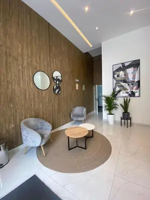a lobby with a table and two chairs and a wall at Exclusive apartment in Miraflores in Lima
