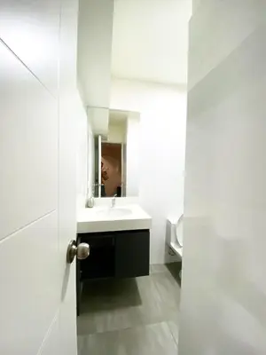 a white bathroom with a sink and a mirror at Exclusive apartment in Miraflores in Lima