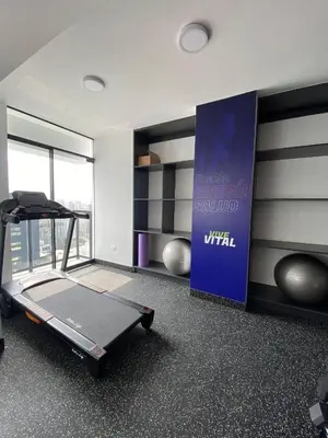 a gym with a treadmill and a sign in a room at Exclusive apartment in Miraflores in Lima