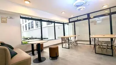a room with tables and a couch and some windows at Exclusive apartment in Miraflores in Lima