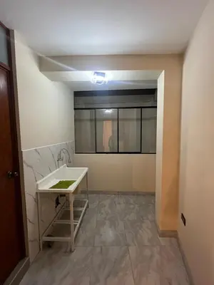 a bathroom with a sink and a table in a room at Departamento de Estreno Amplio y Confortable in Ayacucho