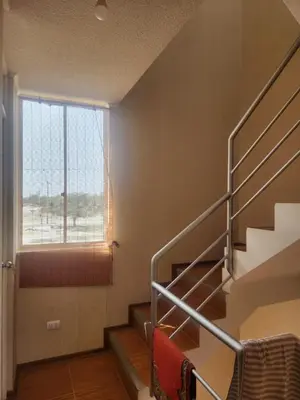 a staircase in a building with a large window at Apartamento duplex en ICA in Pueblo Nuevo