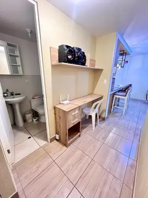 a bathroom with a desk and a sink and a toilet at Downtown apartment in a residential area in Lima in Lima