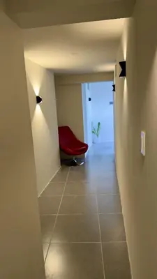 a hallway with a red chair in a room at Habitación Matrimonial en el centro de la ciudad in Ayacucho