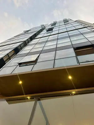 a tall glass building with a lot of windows at Increible vísta al Malecón de Miraflores in Lima