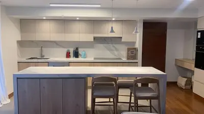 a kitchen with a island with chairs and a counter top at Spacious apartment in Miraflores in Lima