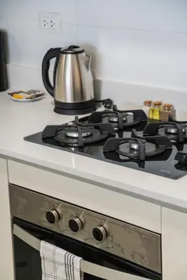 a stove top oven with a tea kettle on it at Brickell 2BR by Geko in Lima