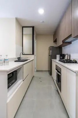 a large kitchen with white counters and appliances at Brickell 2BR by Geko in Lima