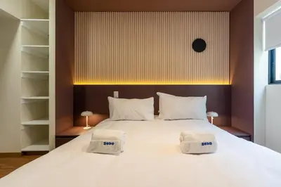 a bedroom with a large white bed with two towels on it at Brickell 2BR by Geko in Lima