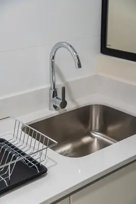 a kitchen sink with a dish drying rack next to it at Brickell 2BR by Geko in Lima