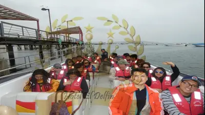 a group of people on a boat in the water at Hotel El Delfin in Lima