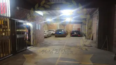 a parking lot with cars parked in a garage at Hotel El Delfin in Lima