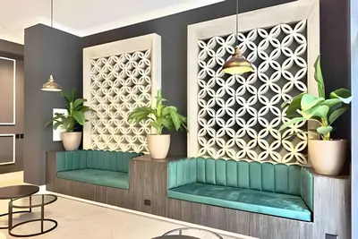 a lobby with green benches and plants at Torre Black in Lima