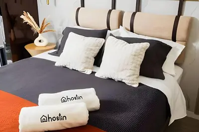 a bedroom with a bed with black and white pillows at Torre Black in Lima