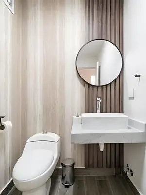 a bathroom with a white toilet and a mirror at Edificio The Classic in Lima