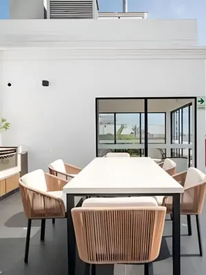 a dining room with a white table and chairs at Edificio The Classic in Lima