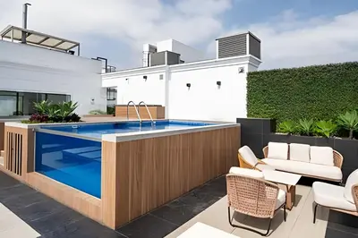 a patio with a swimming pool and a house at Edificio The Classic in Lima