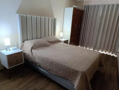 a bedroom with a bed and two lamps on tables at MiniHome Pietra di Prado in Lima