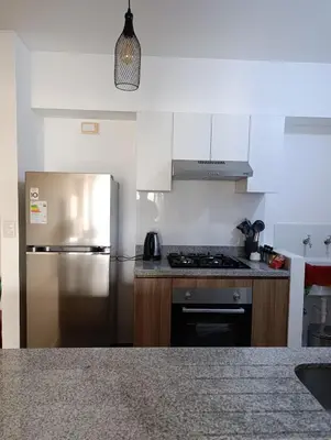 a kitchen with a stainless steel refrigerator and a stove at MiniHome Pietra di Prado in Lima