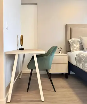 a desk with a green chair next to a bed at Torre Gold in Lima