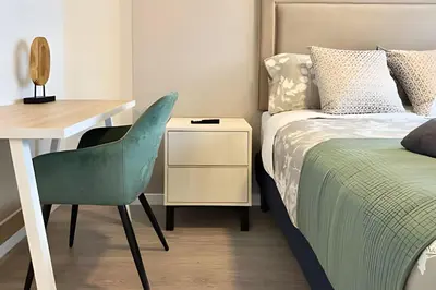 a bedroom with a bed and a desk and a chair at Torre Gold in Lima