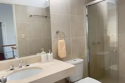 a bathroom with a toilet and a sink and a shower at Iconic Miraflores Penthouse 3BR in Lima